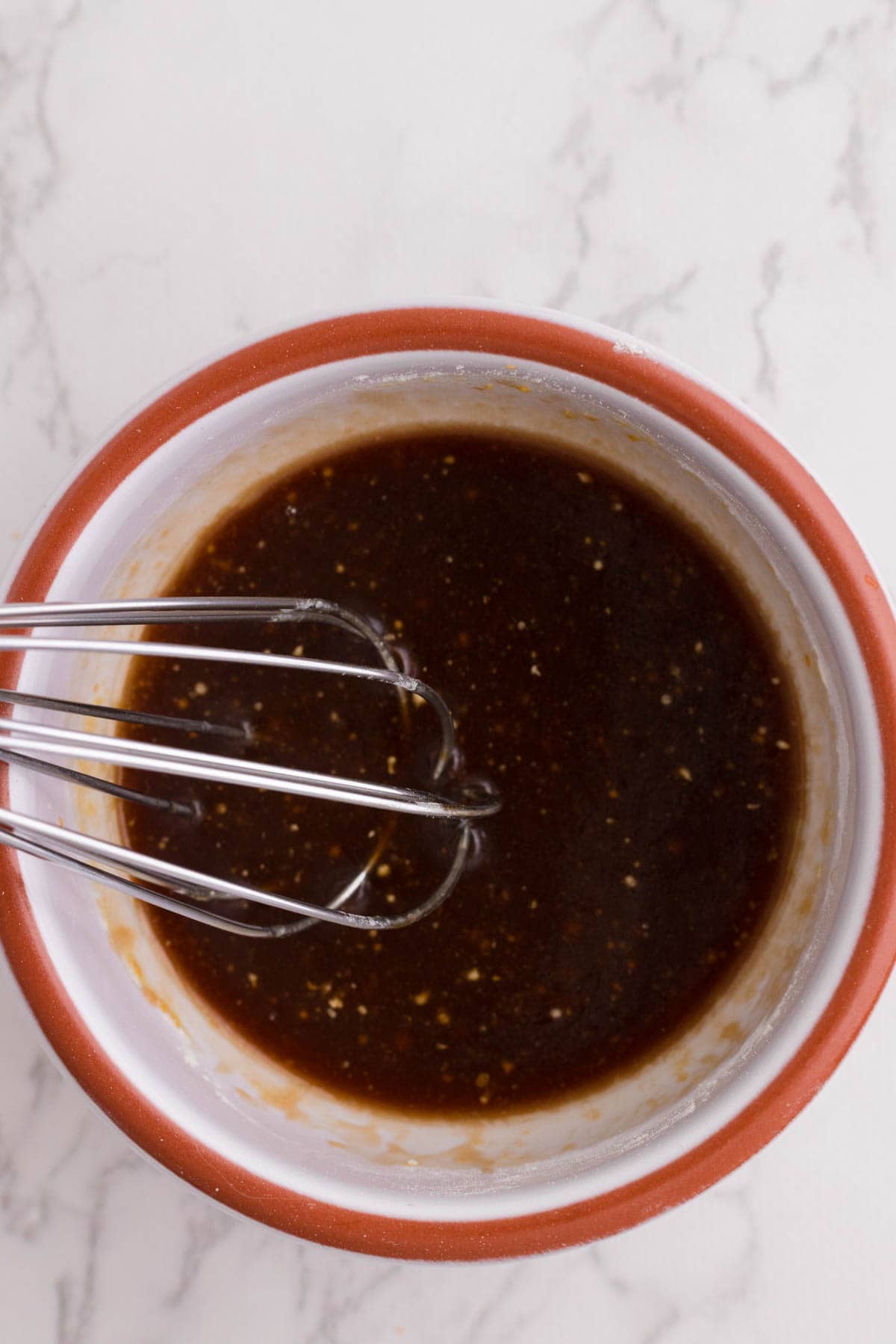 Whisking sauce ingredients together