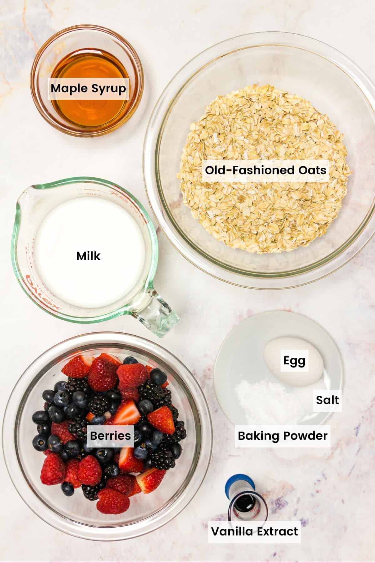 Ingredients to make mixed berry baked oatmeal with text labels.