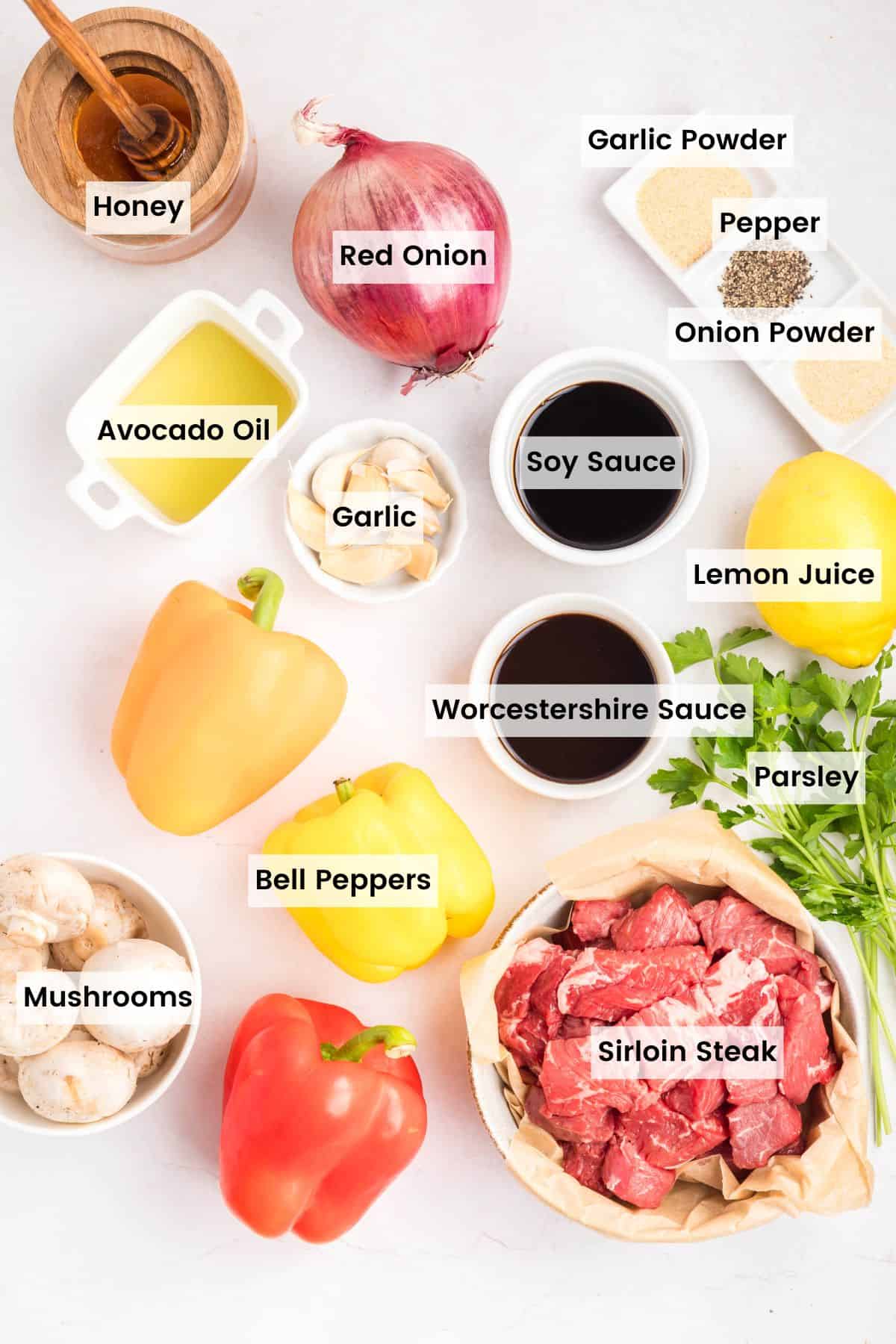 Chunks of sirloin are marinated then threaded onto skewers with onions, bell peppers, and mushrooms to make these beef kebabs. Overhead view of ingredients needed to make beef kebabs