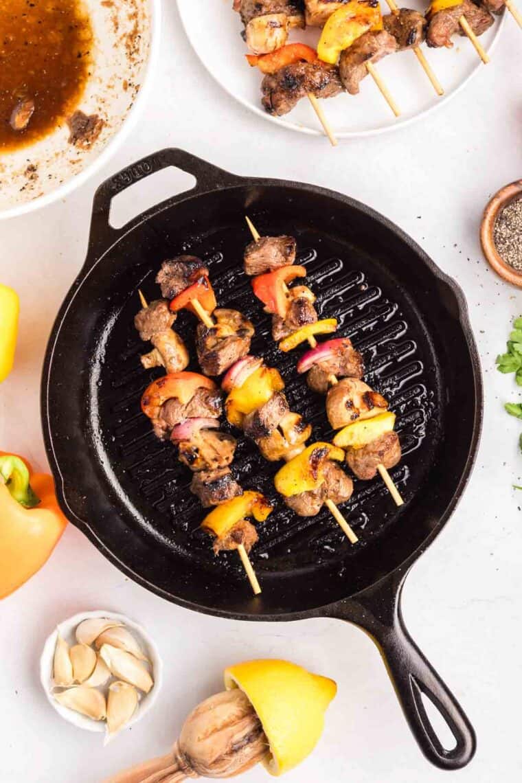Chunks of sirloin are marinated then threaded onto skewers with onions, bell peppers, and mushrooms to make these beef kebabs. Beef kebabs in a skillet