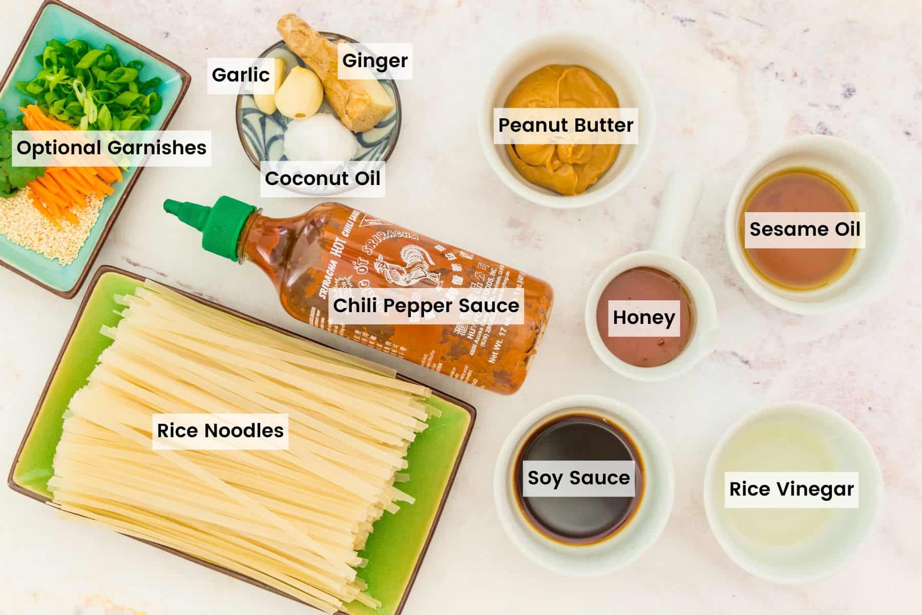 All of the ingredients for Spicy Sesame Noodles laid out on the counter with text labels.