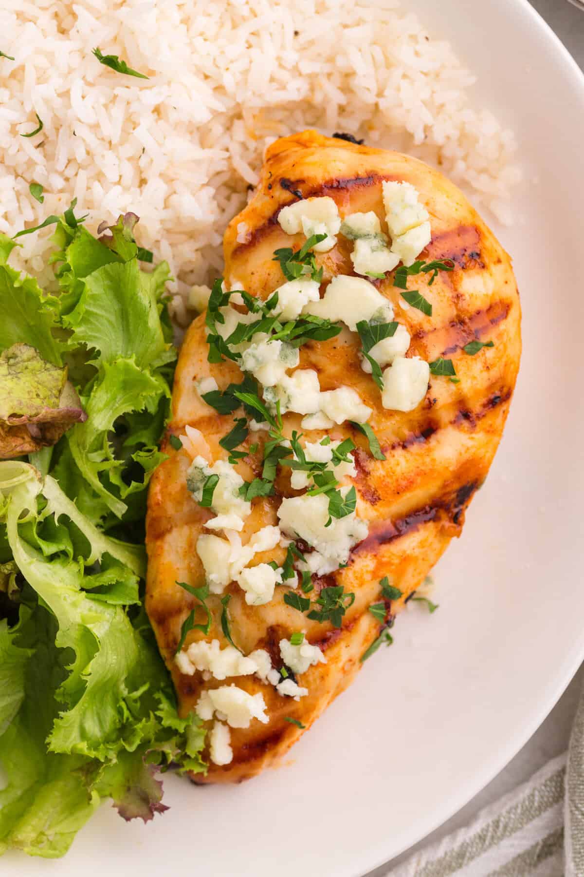 Grilled buffalo chicken topped with blue cheese crumbles and parsley