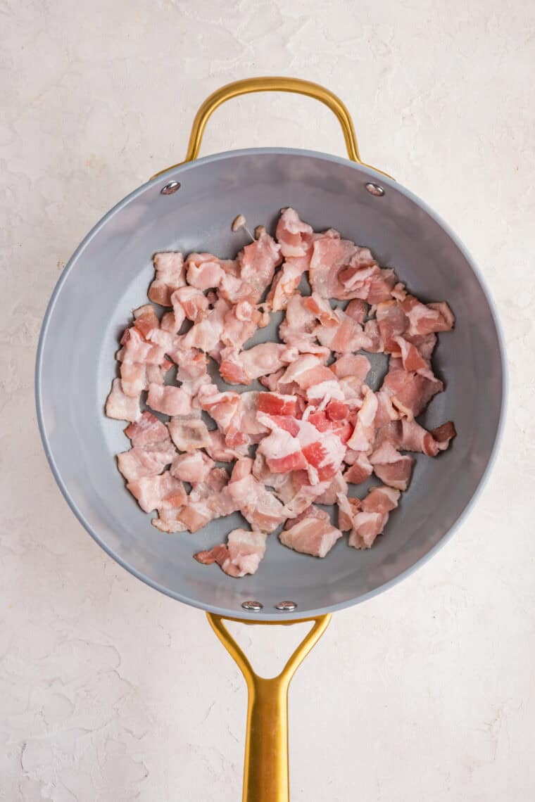 This easy Fried Cabbage recipe turns a handful of ingredients into a savory side dish perfect for busy weeknights & potlucks. Chopped bacon cooking in a skillet