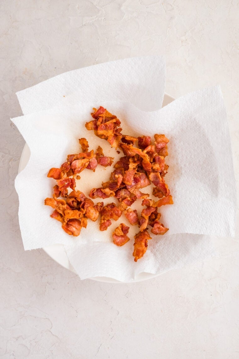 This easy Fried Cabbage recipe turns a handful of ingredients into a savory side dish perfect for busy weeknights & potlucks. Fried bacon draining on paper towels