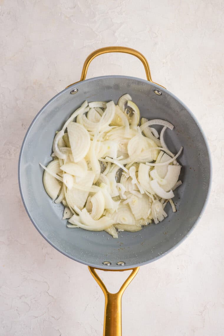 This easy Fried Cabbage recipe turns a handful of ingredients into a savory side dish perfect for busy weeknights & potlucks. Sliced onions in a skillet