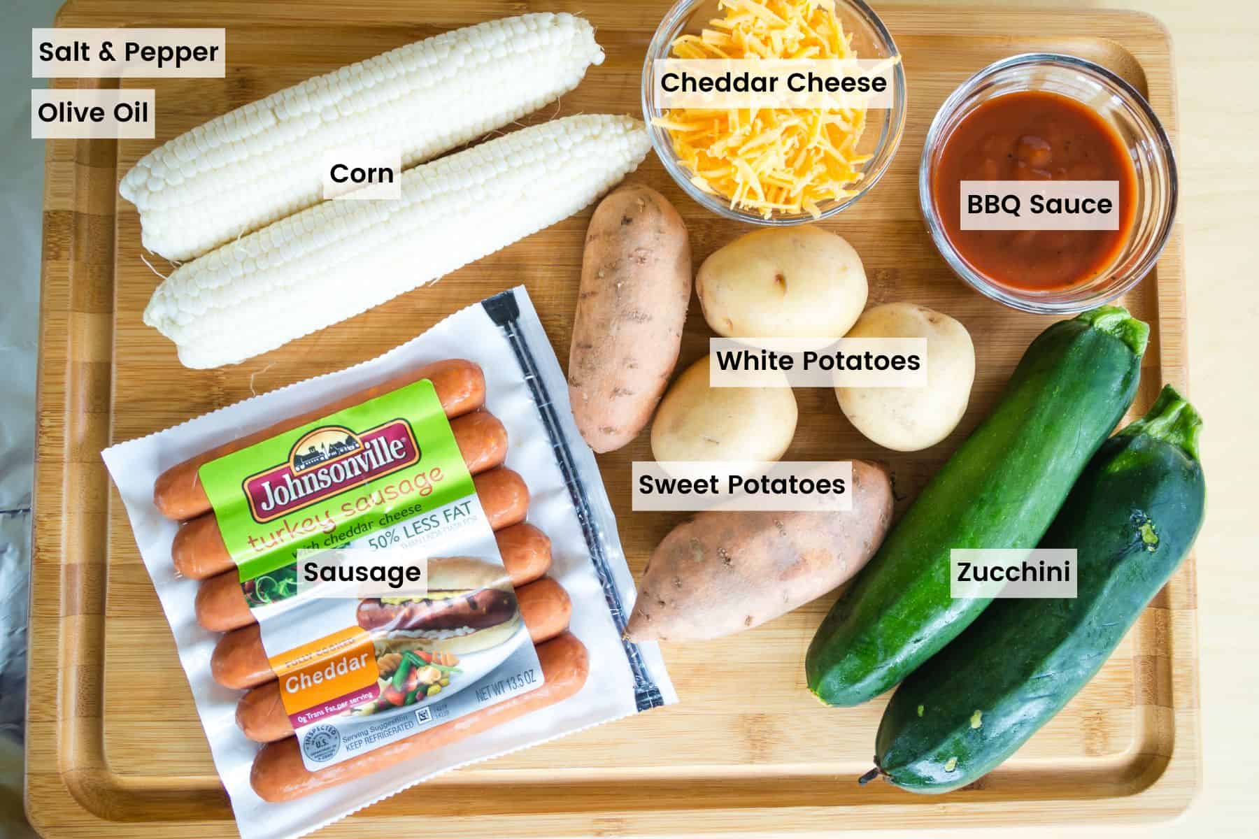 Ingredients to make sausage foil packed with veggies with text labels.
