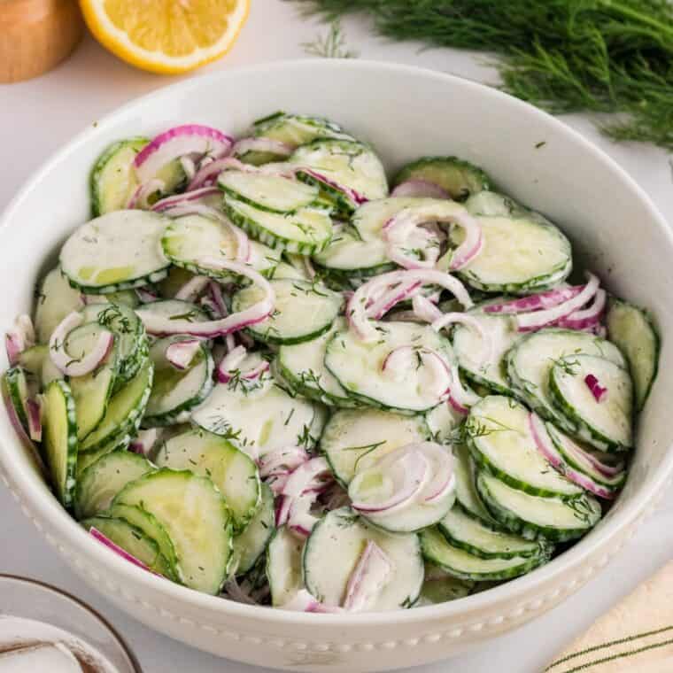 Creamy cucumber salad in a white bowl
