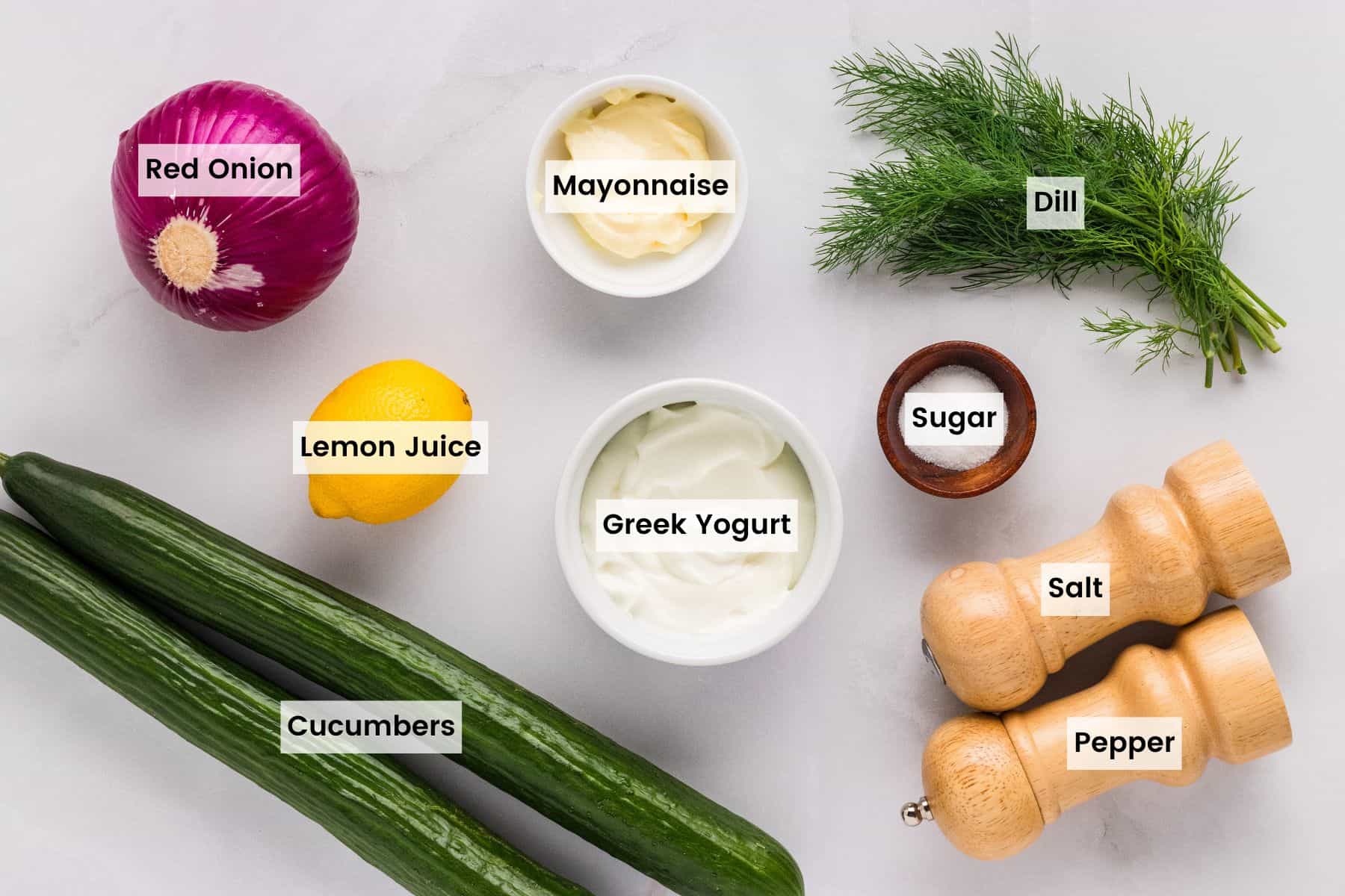 Overhead view of the ingredients needed to make creamy cucumber salad