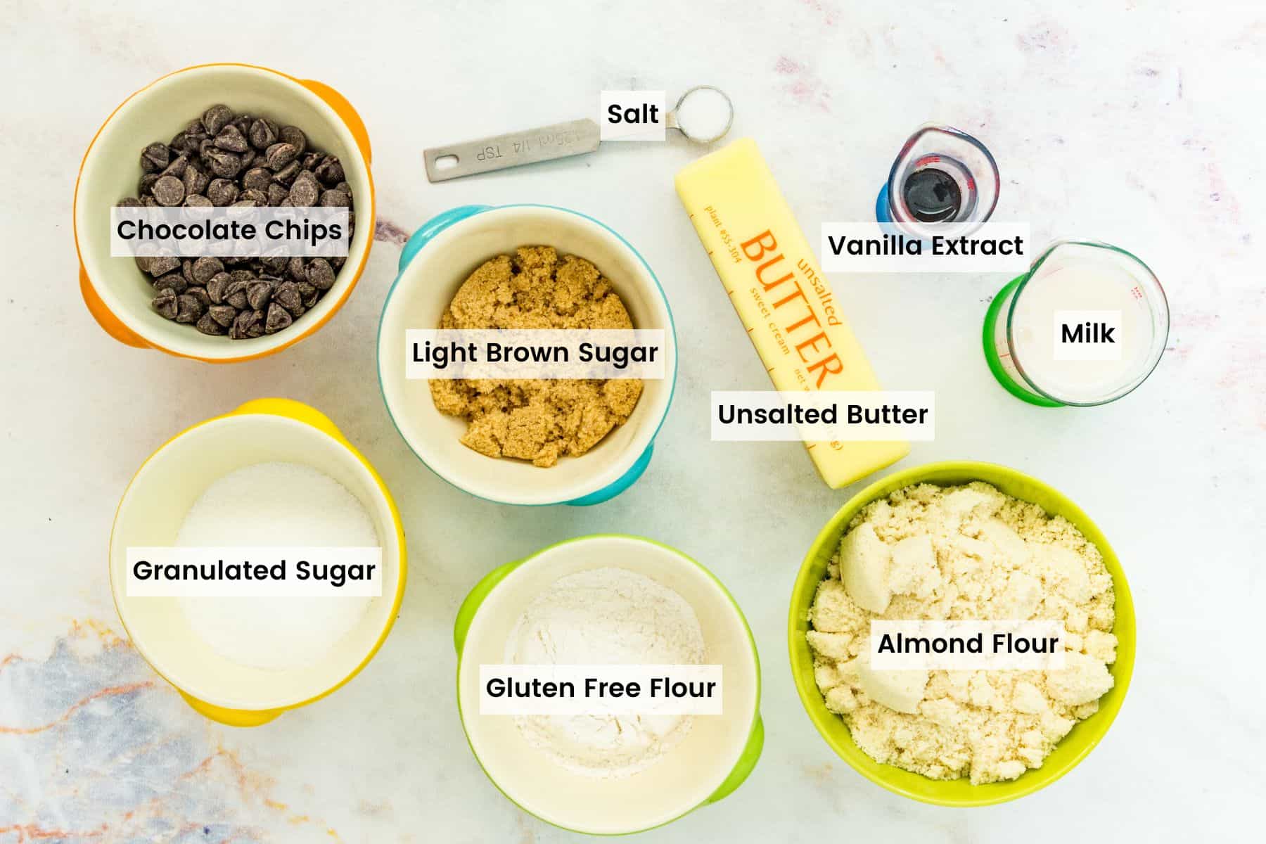 An easy recipe for edible chocolate chip cookie dough that's gluten-free and 100% safe to eat by the spoonful! The perfect sugary treat. The ingredients for gluten-free edible chocolate chip cookie dough with text labels.