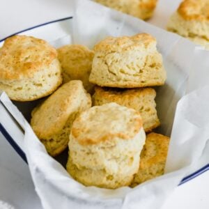 A parchment-lined bowl of shortcake biscuits.