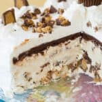 A peanut butter cup ice cream cake with some slices removed with text overlay that says "Homemade Reese's Ice Cream Cake".