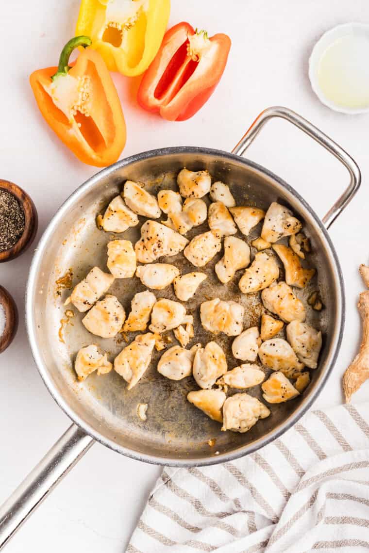 Pieces of chicken cooking in a skillet