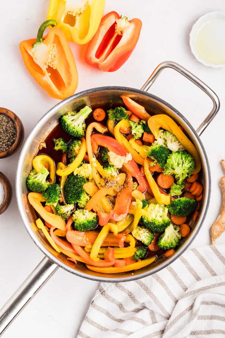 Bell peppers, broccoli, and carrots in a pan