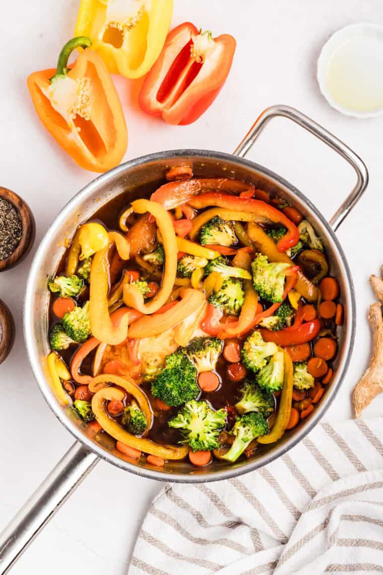 Sauce ingredients added to the veggies in the pan