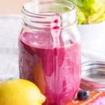 Purple salad dressing in a jar with text overlay that says "Lemon Blueberry Chia Seed Dressing".