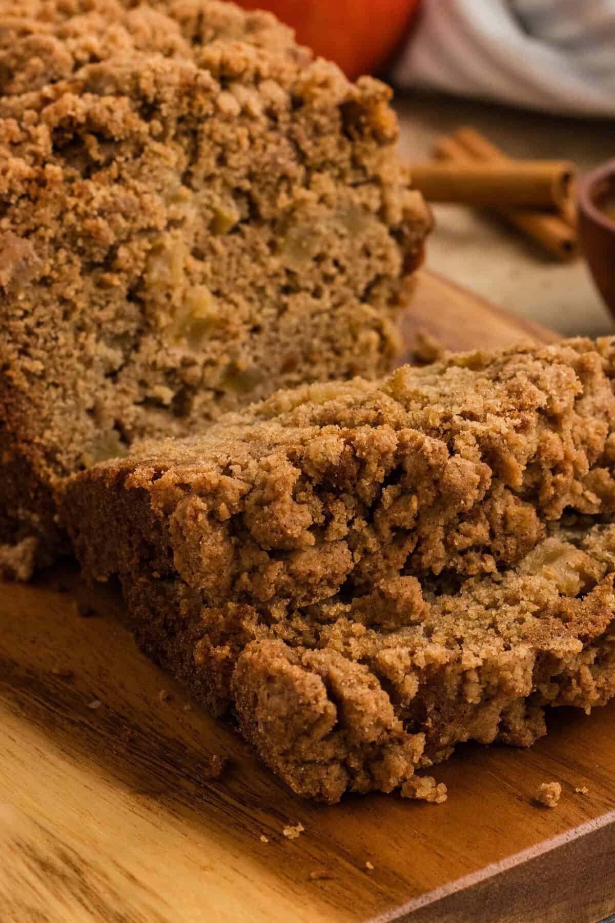 Gluten free apple bread with a few pieces sliced on a cutting board