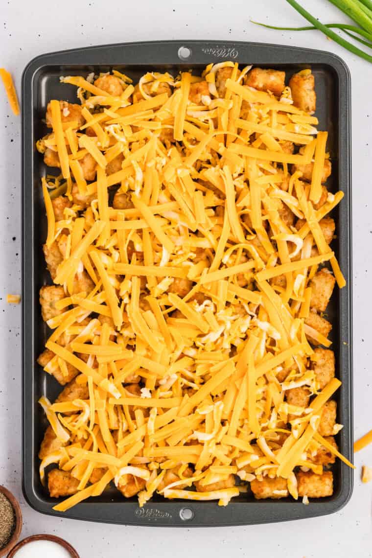 Cheddar cheese on top of tater tots