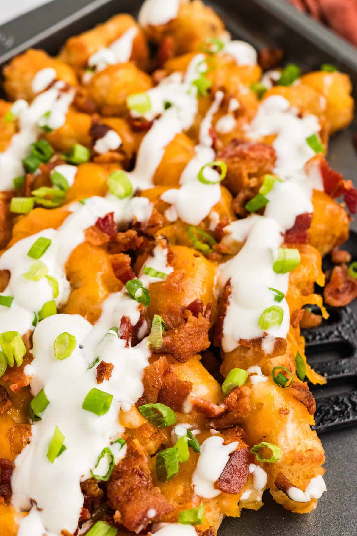 Close up of a pan of loaded tater tots