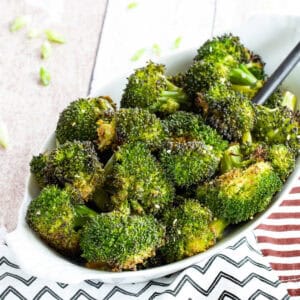 An oval dish of sesame maple broccoli.