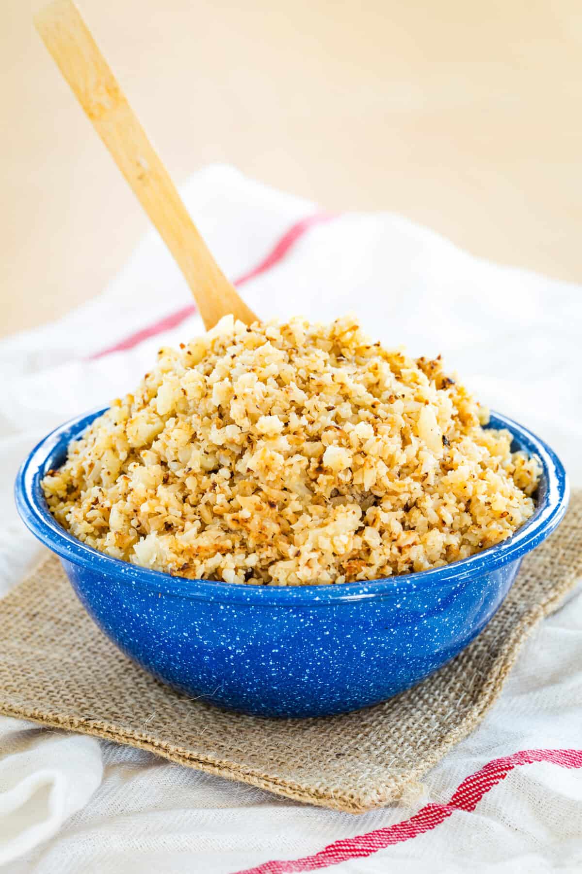 A bowl of cauli rice on top of napkins.