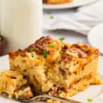A square slice of crockpot breakfast casserole with a fork next to it