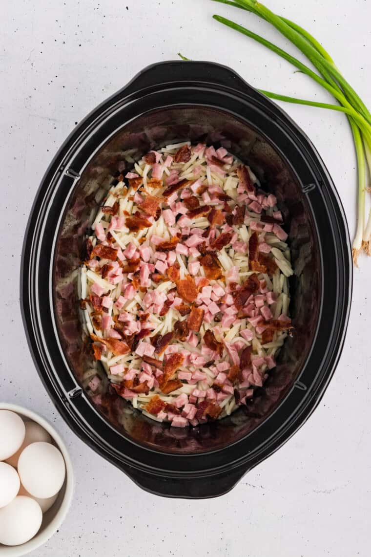 Diced ham and crumbled bacon on top of the hashbrowns