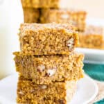 Pumpkin breakfast bars made with oats and quinoa in a stack on a plate.