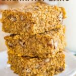 A stack of three bars made with pumpkin, oats, and quinoa on a plate with text that says "Pumpkin Breakfast Bars".