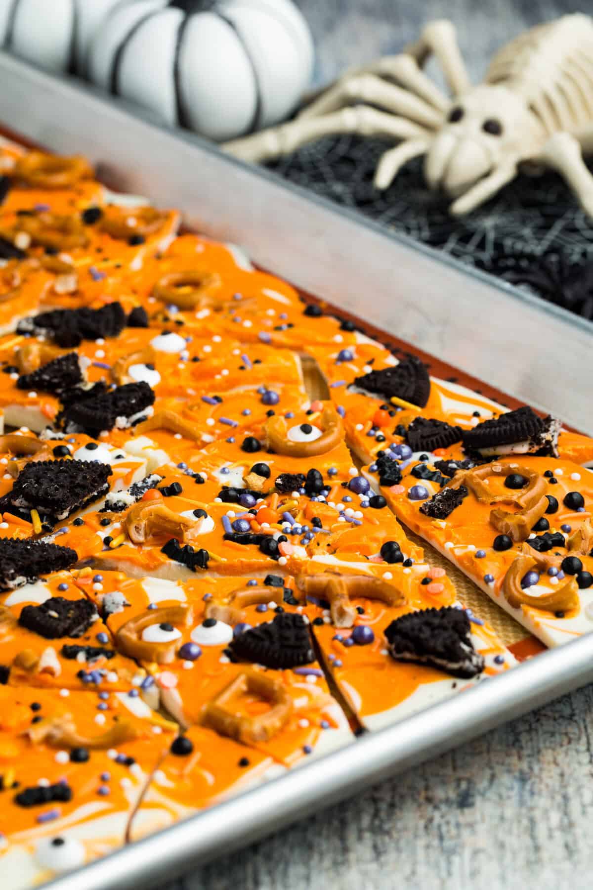 Side angle view of a baking sheet of Halloween bark.