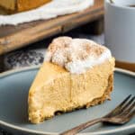 A slice of gluten free no bake pumpkin cheesecake on a blue plate