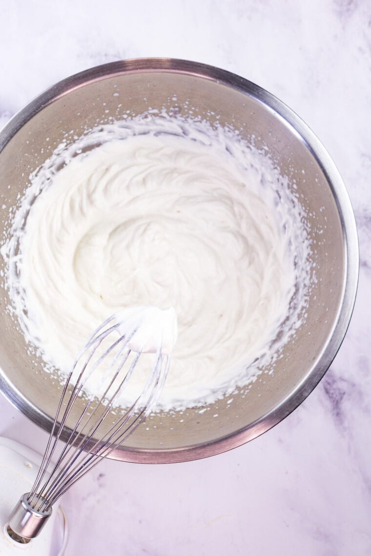 With a graham cracker crust and fluffy pumpkin filling, this gluten free no-bake pumpkin cheesecake is an easy fall dessert. Whipped cream in a bowl